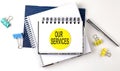 Sticker with OUR SERVICES text on notebooks on white background Royalty Free Stock Photo
