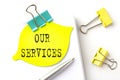 Sticker with OUR SERVICES text on notebooks on the white background Royalty Free Stock Photo