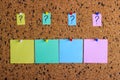 A sticker with a question mark is attached to the cork board. Empty stickers for copy space