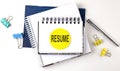 Sticker with RESUME text on the notebooks on the white background Royalty Free Stock Photo