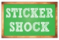 STICKER SHOCK words on green wooden frame school blackboard