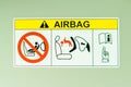 Sticker show how to use child car seat with car airbag, Warning label