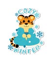 Sticker with symbol of the 2022 year. Cute little tiger is sitting with a cup of tee wrapped up in a cozy blanket Royalty Free Stock Photo