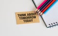 Sticker with text Think About Tomorrow Today with, glasses, colored pencils. Royalty Free Stock Photo