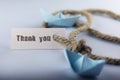 Sticker thank you with thick braided rope and ship paper origami Royalty Free Stock Photo