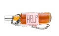 Sticker with word `help!` on bottle with alcohol drink and handcuffs on white