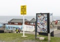 Stickerboard at John O\'Groats with yellow sign giving advice