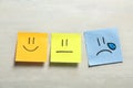 Stickers with drawn happy, sad and unemotional faces on light background, flat lay