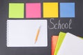 Stickers and an empty sheet for entries on a board on which chalk is written `back to school`