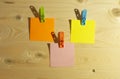 Stickers on multicolor clothes clips lie on a wooden background Royalty Free Stock Photo