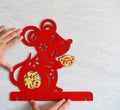 Sticking a fluffy paper-cut as symbol of Chinese New Year of the rat to the wall the Chinese means fortune