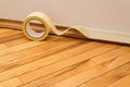 Sticking masking tape to the baseboard