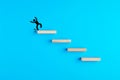 Stickman standing on the edge of wooden stairs is just about to fall. Risk, failure, instability and downfall concept in business