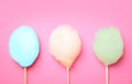 Sticks with different colorful yummy cotton candy on pink background Royalty Free Stock Photo