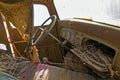 Sticks and dust have accumulated in the interior of a wrecked antique truck Royalty Free Stock Photo