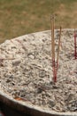 Sticks of incense were put in a bowl in the courtyard of a buddhist temple (Thailand)