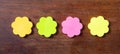 Sticky colorful notes in flower shape, , copy space on wooden background.