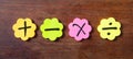 Sticky colorful notes in flower shape, , with math symbols on wooden background.