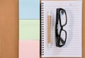 sticky note, ballpoint pen, empty notebook, eyeglasses on office Royalty Free Stock Photo