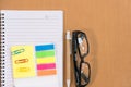 sticky note, ballpoint pen, empty notebook, eyeglasses on office Royalty Free Stock Photo