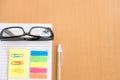 sticky note, ballpoint pen, empty notebook, eyeglasses on office Royalty Free Stock Photo