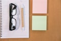 sticky note, ballpoint pen, empty notebook, eyeglasses on office Royalty Free Stock Photo