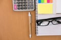 sticky note, calculator, ballpoint pen, empty notebook, eyeglass Royalty Free Stock Photo