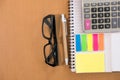 sticky note, calculator, ballpoint pen, empty notebook, eyeglass Royalty Free Stock Photo