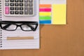 sticky note, calculator, ballpoint pen, empty notebook, eyeglass Royalty Free Stock Photo