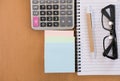 sticky note, calculator, ballpoint pen, empty notebook, eyeglass Royalty Free Stock Photo