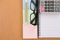 Sticky note, calculator, ballpoint pen, empty notebook, eyeglasses on office desk. business, accountant concept. Top view with cop Royalty Free Stock Photo