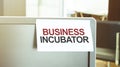 Sticky note on the computer. Text BUSINESS INCUBATOR Royalty Free Stock Photo
