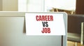 Sticky note on the computer. Text CAREER VS JOB Royalty Free Stock Photo