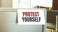 Sticky note on the computer. Text PROTECT YOURSELF Royalty Free Stock Photo