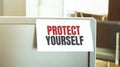 Sticky note on the computer. Text PROTECT YOURSELF Royalty Free Stock Photo