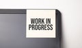 Sticky note on the computer. Text work in progress Royalty Free Stock Photo