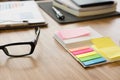 sticky note, eyeglasses, notebook on office desk. business, work Royalty Free Stock Photo