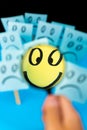 Sticky note with hand drawn Smiley face looked through the magnifying glass with Sad faces in background. Positive way of thinking