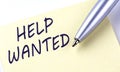 Sticky Note Message HELP WANTED with pen on the white background Royalty Free Stock Photo