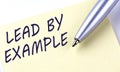 Sticky Note Message LEAD BY EXAMPLE with pen on the white background Royalty Free Stock Photo