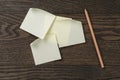 Sticky note reminder on oak wood table with pencil