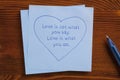 Sticky note with text Love is not what you say.Love is what you Royalty Free Stock Photo