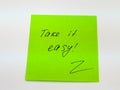 Sticky note with text take it easy Royalty Free Stock Photo