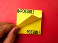 Sticky note with the word IMPOSSIBLE POSSIBLE Royalty Free Stock Photo