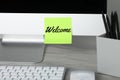 Sticky note with word Welcome on computer monitor in office Royalty Free Stock Photo