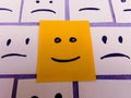 sticky notes with All sad and one Happy face - Unhappy and Happy Team Concept Royalty Free Stock Photo