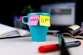 Sticky notes on a coffe cup at office desk. Wake up concept Royalty Free Stock Photo