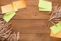 Sticky notes and color pencils on wooden desk Royalty Free Stock Photo