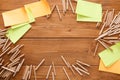 Sticky notes and color pencils on wooden desk Royalty Free Stock Photo