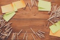 Sticky notes and color pencils on wooden desk Royalty Free Stock Photo